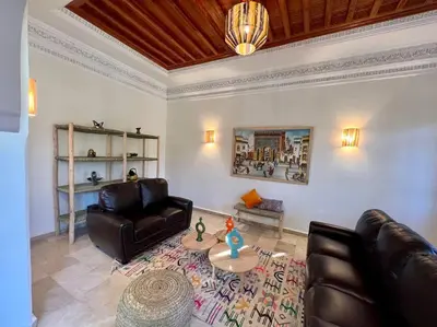 a living room with two leather chairs and a table at Villa 1 by Majestic Properties in Marrakech
