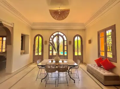 a dining room with a table and chairs at Villa 1 by Majestic Properties in Marrakech
