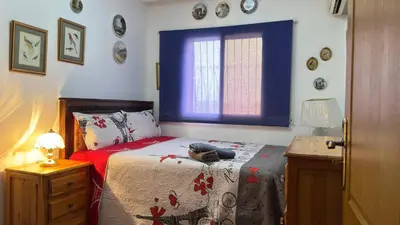 a bedroom with a bed and a window and a table at شقة الفن Art Apartment in Marrakech