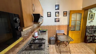 a kitchen with a stove and a chair in it at شقة الفن Art Apartment in Marrakech
