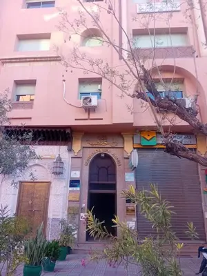 a pink building with a door at شقة الفن Art Apartment in Marrakech