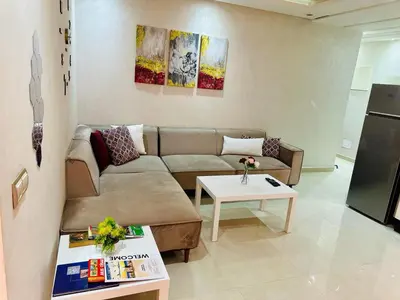 a living room with a couch and a table at Chic & Lovely Flat in City Center in Marrakech