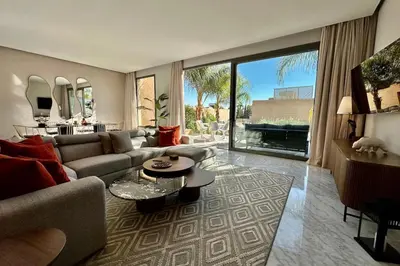a living room with a couch and a table at Luxury living/Terrace/Pool in Marrakech