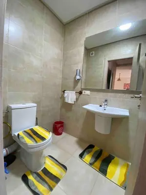 a bathroom with a toilet and a sink and a mirror at Appartement Marrakech luxe in Marrakech