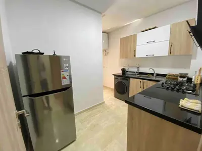 a kitchen with a stainless steel refrigerator and a stove at Appartement Marrakech luxe in Marrakech