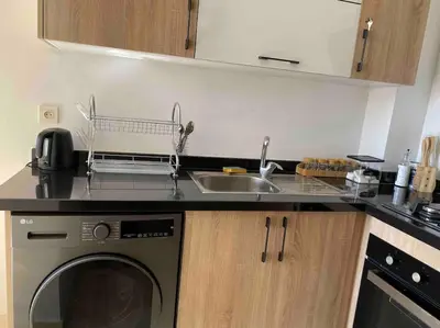 a kitchen with a sink and a washing machine at Appartement Marrakech luxe in Marrakech