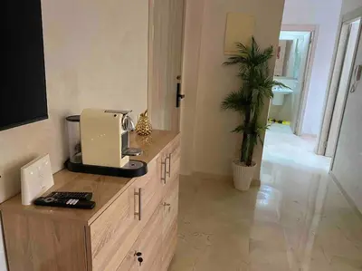 a kitchen with a coffee machine on a wooden counter at Appartement Marrakech luxe in Marrakech
