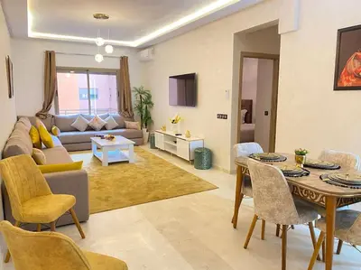 a living room with a couch and a table at App centre-ville in Marrakech