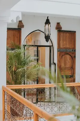 a balcony with a mirror and a table at Riad Babel au coeur de la Médina in Marrakech