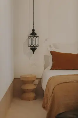 a bedroom with a bed and a chandelier at Riad Babel au coeur de la Médina in Marrakech