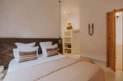a bedroom with a large white bed with pillows at Riad Babel au coeur de la Médina in Marrakech