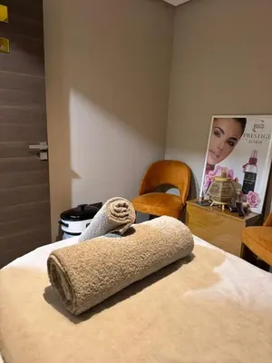 a room with a bed with a towel on it at Swiss Continental Hôtel in Marrakech