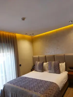 a bedroom with a large bed and a window at Swiss Continental Hôtel in Marrakech
