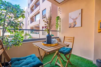 a balcony with a table and chairs and a window at Royal KING Bed SUITE W/POOL in Marrakech