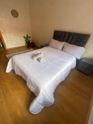 a large white bed with two towels on it at Luxury apart à Gueliz Marrakech in Marrakech