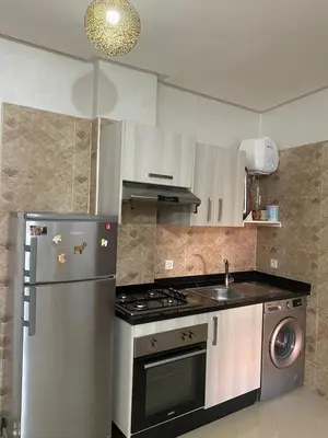 a kitchen with a stainless steel refrigerator and a sink at Luxury apart à Gueliz Marrakech in Marrakech