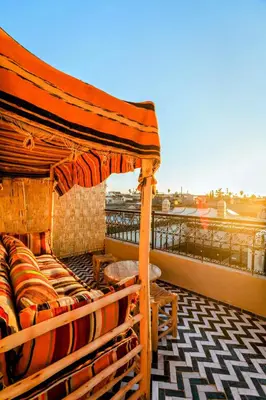 a bed on the roof of a building at Riad Zazz in Marrakech