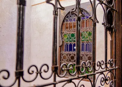 a iron gate with a window on a wall at Riad Zazz in Marrakech