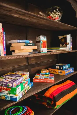 a shelf filled with books and a pile of blankets at Riad Zazz in Marrakech