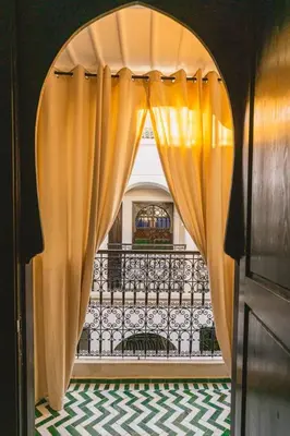 an entrance to a balcony with an open curtain at Riad Zazz in Marrakech