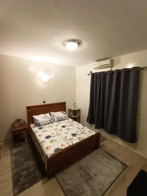 a bedroom with a bed and a window with a curtain at 1 Room only for women للنساء فقط in Marrakech