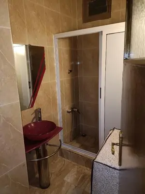 a bathroom with a shower and a red sink at 1 Room only for women للنساء فقط in Marrakech