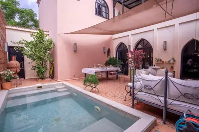 a house with a swimming pool in a courtyard at Dar Ines - Palmeraie, 250m2, pool, patio, terrace in Marrakech