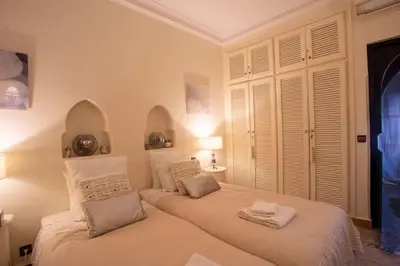 a bedroom with a large bed with two pillows at Dar Ines - Palmeraie, 250m2, pool, patio, terrace in Marrakech