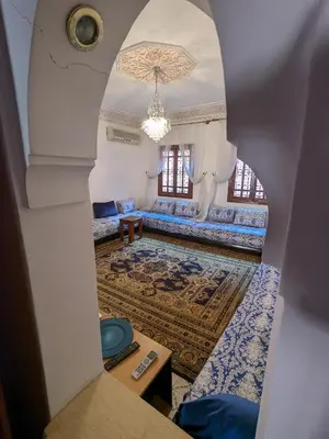 a view of a living room through an archway at Nahe Park Issil und Marjane. Yoga auf Anfrage. in Marrakech