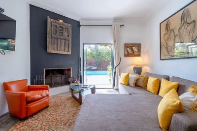 a living room with a couch and a fireplace at Private Villa Comfort & Relax-Heated Pool in Marrakech