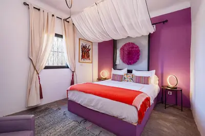 a bedroom with purple walls and a large bed at Private Villa Comfort & Relax-Heated Pool in Marrakech