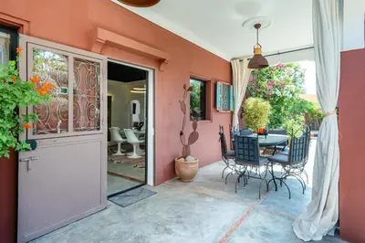 a patio with a table and chairs and a door at Private Villa Comfort & Relax-Heated Pool in Marrakech
