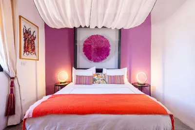 a bedroom with a large bed with purple walls at Private Villa Comfort & Relax-Heated Pool in Marrakech