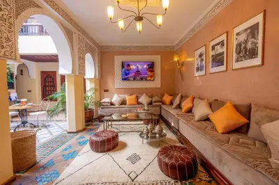 a living room with a couch and a table at Riad Amalia in Marrakech