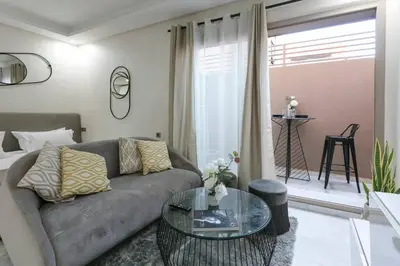 a living room with a couch and a glass table at African Dream - Marrakech Centre in Marrakech