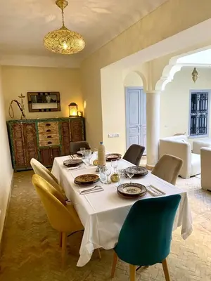 a dining room with a table and chairs at Riad le R - Riad privatif de luxe in Marrakech