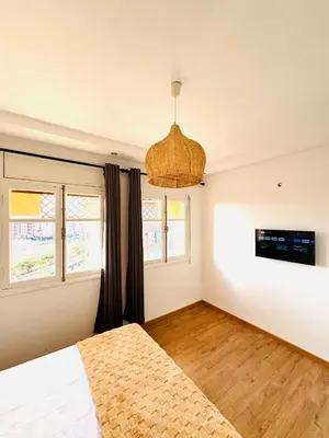 a bedroom with a bed and two windows at Musée YSL Cozy, Familial, Chic in Marrakech