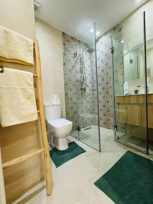 a bathroom with a toilet and a glass shower at Musée YSL Cozy, Familial, Chic in Marrakech