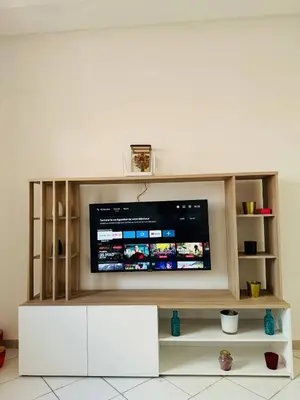 a entertainment center with a flat screen tv at Musée YSL Cozy, Familial, Chic in Marrakech