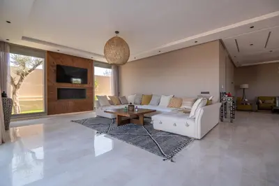a living room with a couch and a table at Villa Saadia in Douar Bellouk