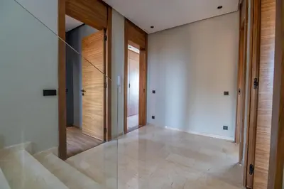 a hallway with a mirror and stairs in a house at Villa Saadia in Douar Bellouk