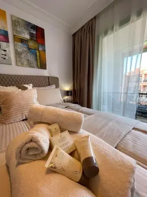 a bedroom with two beds with towels and a window at appartement luxueux /confort , l’hivernage(Guéliz) au cœur de Marrakech in Marrakech