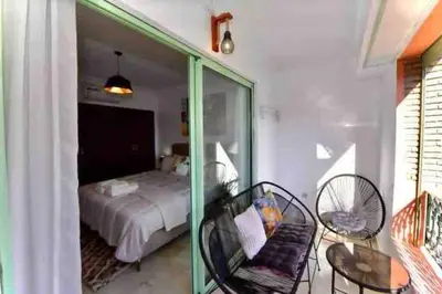 a bedroom with a bed and a table and chairs at appartement luxueux /confort , l’hivernage(Guéliz) au cœur de Marrakech in Marrakech
