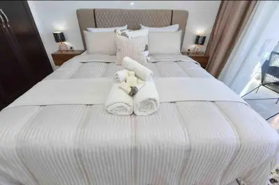 a bedroom with two white towels on a bed at appartement luxueux /confort , l’hivernage(Guéliz) au cœur de Marrakech in Marrakech
