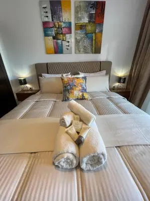 a stuffed animal is laying on a bed at appartement luxueux /confort , l’hivernage(Guéliz) au cœur de Marrakech in Marrakech