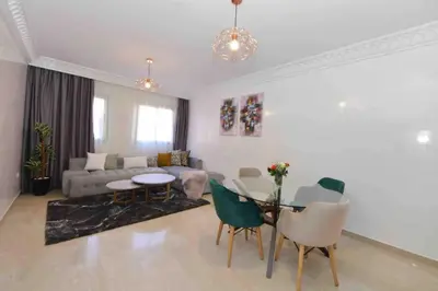 a living room with a table and a couch at appartement luxueux /confort , l’hivernage(Guéliz) au cœur de Marrakech in Marrakech