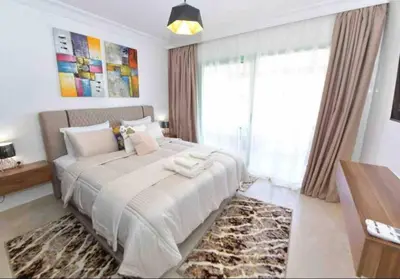 a bedroom with a large bed and a large window at appartement luxueux /confort , l’hivernage(Guéliz) au cœur de Marrakech in Marrakech