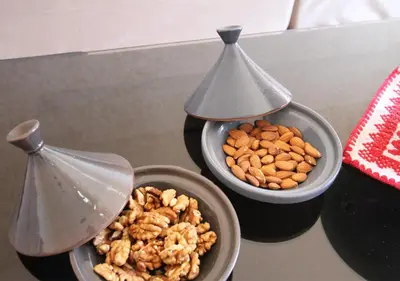 a table with two bowls of nuts and a funnel at appartement confort calme propre WIFI in Marrakech
