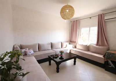 a living room with a couch and a table at appartement confort calme propre WIFI in Marrakech