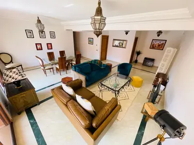 a living room with a couch and a table at Appartement Résidence de standing Hivernage in Marrakech